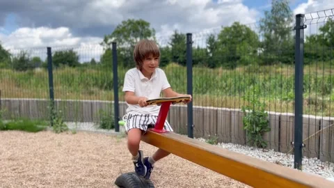 Playground swing boy riding a swing Stock Footage 247448259