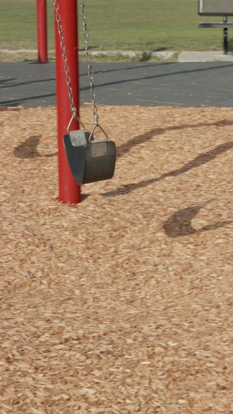 Playground Swing in Vertical Tracking Pan Stock Footage 345102515