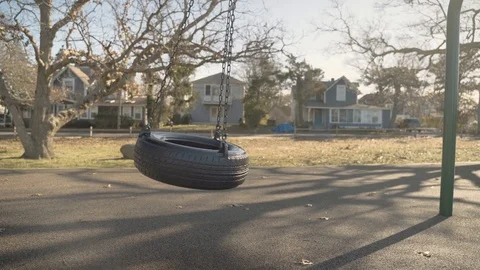 Playground Tire Swing Moving. Empty Tire Swinging At Park On Beautiful Sunny Day Stock Footage 125625824