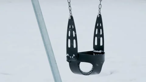 Playground Toddler Swing in Winter Snowfall Video Stock Footage 332376764
