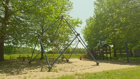 A playground with trees overlooking a large field. Stock Footage 244582682