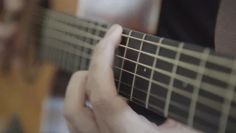 Playing an acoustic guitar (close up) Видео 84792180
