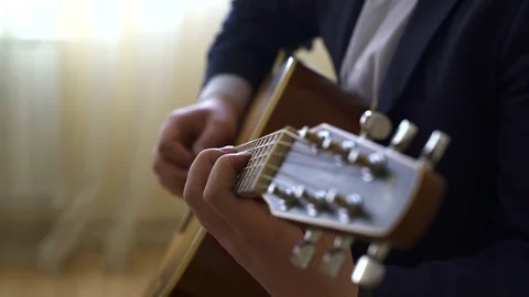 Playing acoustic guitar Stock Footage 73578088