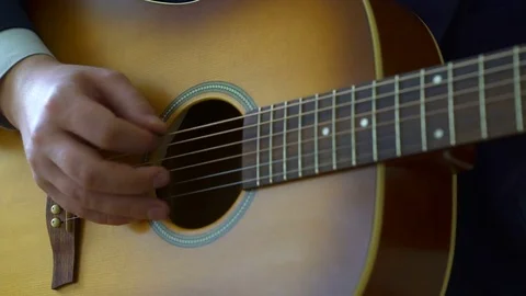 Playing acoustic guitar Stock Footage 73578193