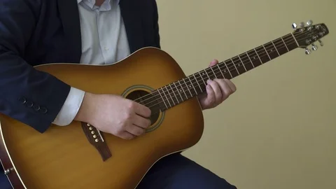 Playing acoustic guitar Stock Footage 73578221