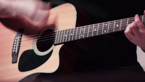 Playing on an acoustic guitar Stock Footage