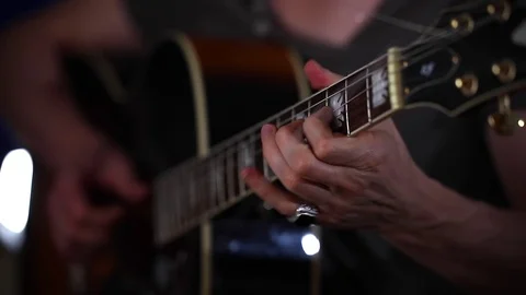Playing acoustic guitar side angle close up strumming left hand Stock Footage 80321357