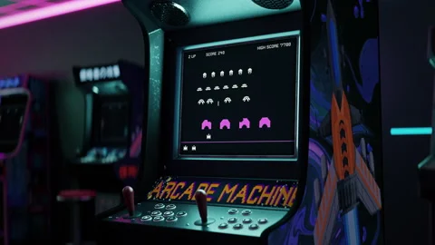 Playing Alien Defence Classic Video Game With 2D Graphics On Arcade Cabinet Stock Footage 243803229