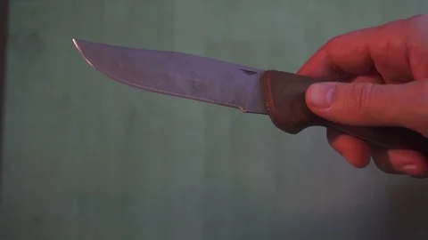 Playing with and opening folding knife Stock Footage 105471131