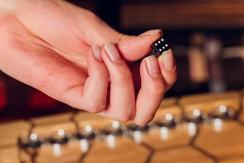 Playing backgammon game. Man play board game. Dice on wooden board. Stock Photos