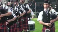 Playing bagpipe band entering Highland Gathering HD Footage