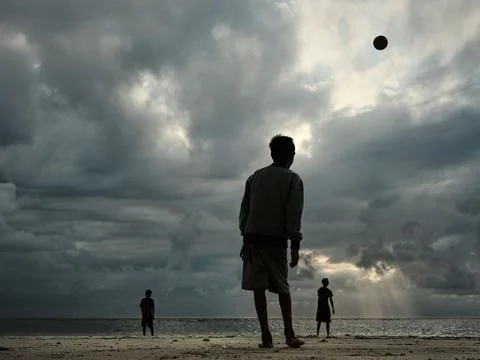 PLAYING BALL ON THE BEACH Stock Photos
