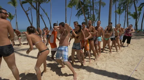 Playing a ball relay game on the beach, Dominican Republic Stock Footage 50680845
