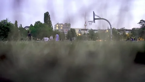 Playing Bascket Ball in a Park in Berlin, TV Tower in Back Groud Stock Footage 253639680