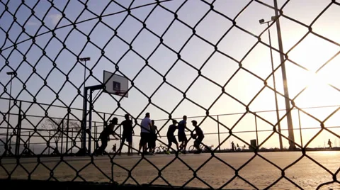 Playing Basketball ,In The Sunset,Behind The Wire Mash  Stock Footage 37534622