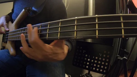 Playing bass guitar at a recording studio Stock Footage 101574724