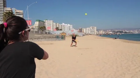 Playing beach paddle Stock Footage 77047347