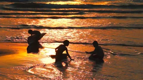 Playing on the Beach at Sunset Video stock 21034374
