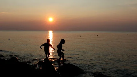 Playing at the Beach at Sunset Stock Footage 88518075