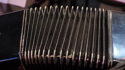 Playing on a big accordion. Playing the harmonica close-up. Old musical Stockbeeldmateriaal 82339389