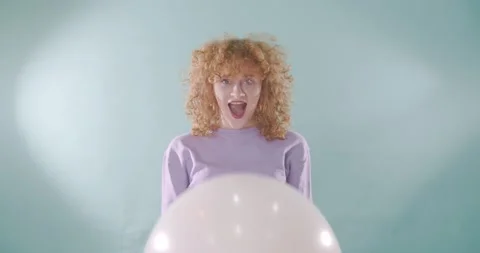 Playing with the big balloon while making faces Stock Footage 155026648