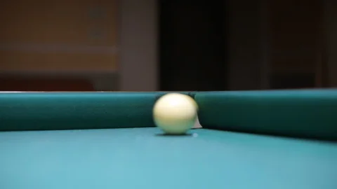 Playing billiard - The player hits the number 10 ball that goes into the hole. Stock Footage 129179451