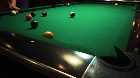 Playing billiards, blowing a cue on the ball, the ball hit the pocket, the ball Stock Footage 77144127