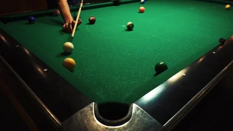 Playing billiards, blowing a cue on the ball, the ball hit the pocket, the ball Stock Footage 77144611