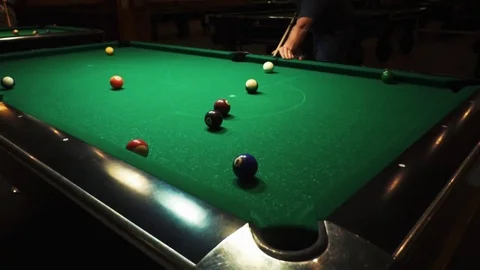 Playing billiards, blowing a cue on the ball, the ball hit the pocket, the ball Stock Footage 77145217