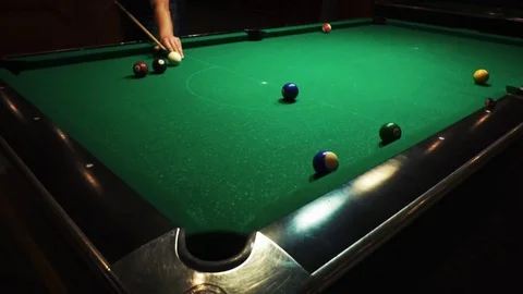 Playing billiards, blowing a cue on the ball, the ball hit the pocket, the ball Stock Footage 77145880