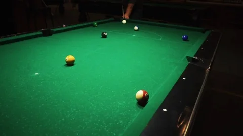 Playing billiards, blowing a cue on the ball, the ball hit the pocket, the ball Stock Footage 77146217