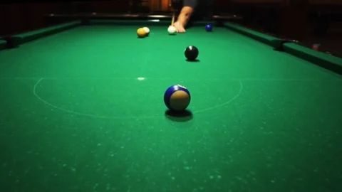 Playing billiards, blowing a cue on the ball, the ball hit the pocket, the ball Stock Footage 77146554