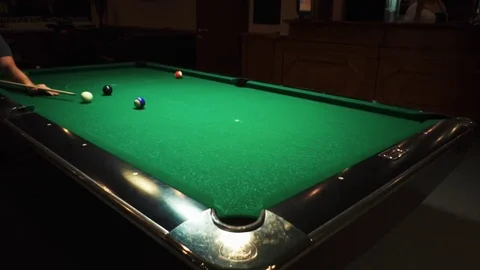 Playing billiards, blowing a cue on the ball, the ball hit the pocket, the ball Stock Footage 77146913
