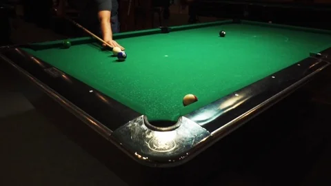 Playing billiards, blowing a cue on the ball, the ball hit the pocket, the ball Stock Footage 77147270