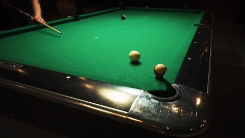 Playing billiards, blowing a cue on the ball, the ball hit the pocket, the ball Stock Footage 77147793