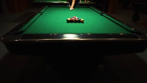 Playing billiards, blowing a cue on the ball, the ball hit the pocket, the ball Stock Footage 77150277