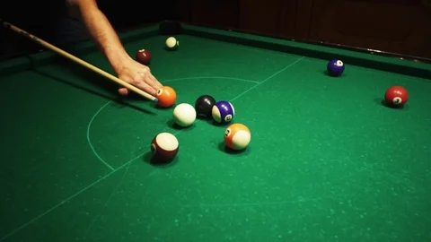 Playing billiards, blowing a cue on the ball, the ball hit the pocket, the ball Stock Footage 77150627