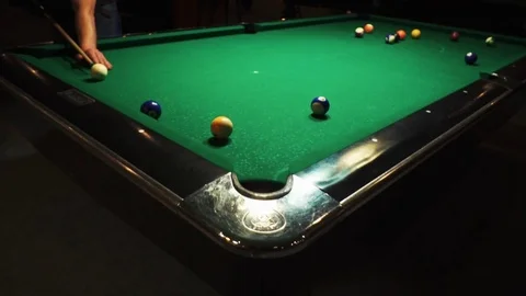 Playing billiards, blowing a cue on the ball, the ball hit the pocket, the ball Stock Footage 77151162