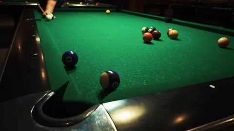 Playing billiards, blowing a cue on the ball, the ball hit the pocket, the ball Stock Footage 77151333