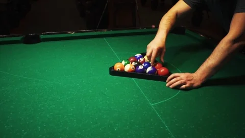 Playing billiards, blowing a cue on the ball, the ball hit the pocket, the ball Stock Footage 77277664