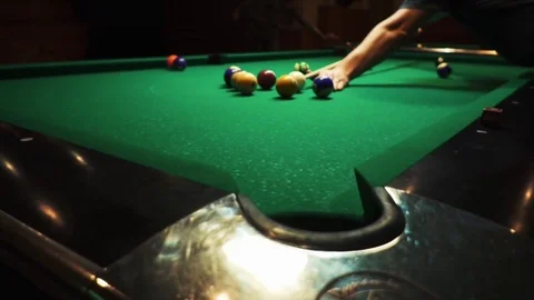 Playing billiards, blowing a cue on the ball, the ball hit the pocket, the ball Stock Footage 77277916