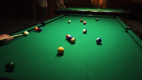 Playing billiards, blowing a cue on the ball, the ball hit the pocket, the ball Stock Footage 77278002