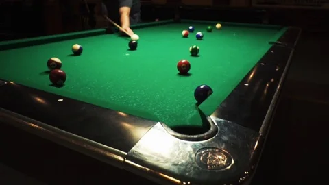 Playing billiards, blowing a cue on the ball, the ball hit the pocket, the ball Stock Footage 77278091