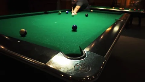 Playing billiards, blowing a cue on the ball, the ball hit the pocket, the ball Stock Footage 77278423