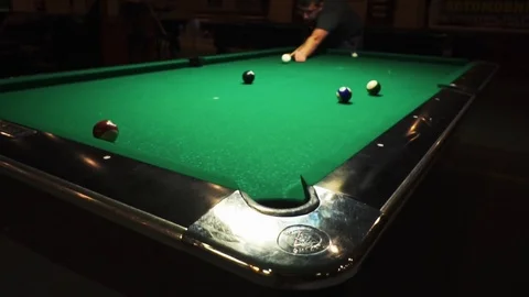 Playing billiards, blowing a cue on the ball, the ball hit the pocket, the ball Stock Footage 77278513
