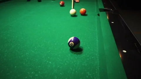 Playing billiards, blowing a cue on the ball, the ball hit the pocket, the ball Stock Footage 77280099