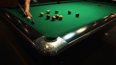 Playing billiards, blowing a cue on the ball, the ball hit the pocket, the ball Stock Footage 77281106