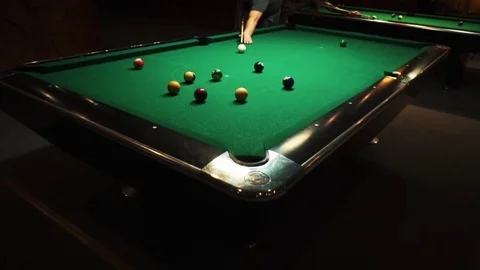 Playing billiards, blowing a cue on the ball, the ball hit the pocket, the ball Stock Footage 77281254