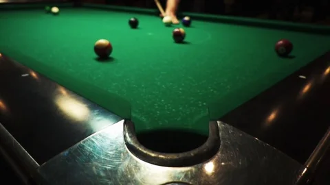 Playing billiards, blowing a cue on the ball, the ball hit the pocket, the ball Stock Footage 77281384