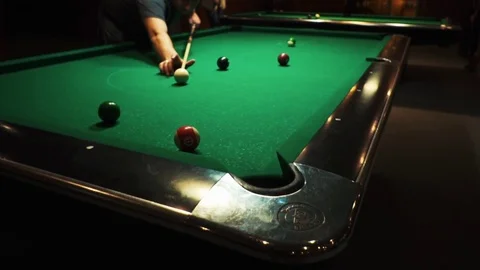 Playing billiards, blowing a cue on the ball, the ball hit the pocket, the ball Stock Footage 77281504
